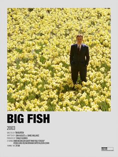 a man in a suit and hat standing in a field of flowers with the words big fish on it