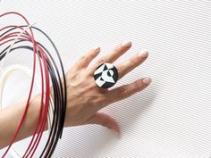 This bold geometric ring is an astonishing eye-catcher. It's large black and white unusual 3D printed ring and surely will not go unnoticed.  Statement ring, suitable both for everyday use and also for special occasions. First designed in CAD 3D modeling software then made from PLA plastic (biodegradable thermoplastic derived from corn) by 3D printer. On 3D printed part is attached adjustable stainless steel ring base (silver plated, lead and nickel free). -Colour- Black & White Collection -Pack Printed Ring, 3d Printed Ring, Black And White Jewelry, 3d Printed Jewelry, Unusual Rings, Chunky Ring, Geometric Ring, Chunky Rings, Ring Black