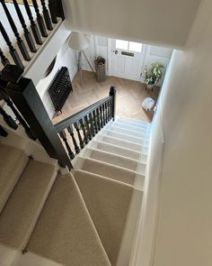 an overhead view of a staircase with carpeted steps leading up to the second floor