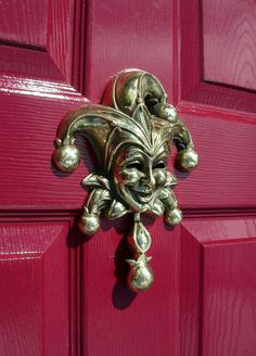 a red door with a metal mask on it