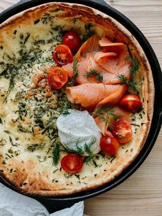 a pan filled with food on top of a wooden table