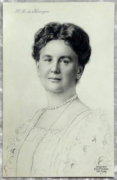 an old black and white photo of a woman with pearls on her necklace, wearing a dress