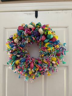 a colorful wreath hanging on the front door