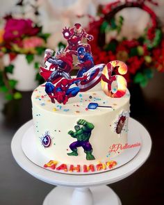 a birthday cake decorated with the characters of avengers and captain america on it's side