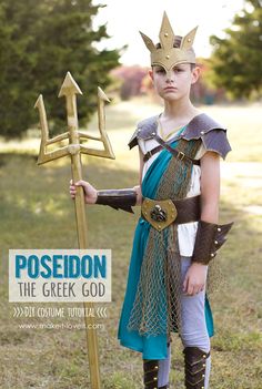 a young boy dressed up as poseion holding a golden sceptacle and an arrow