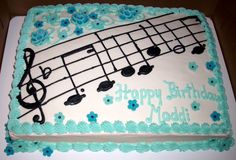 a sheet cake decorated with music notes and flowers