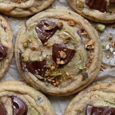 there are many cookies that have chocolate on top of each one and nuts in the middle