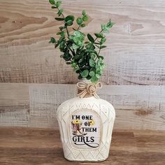 a vase with some green plants in it