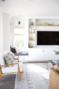 a living room filled with furniture and a flat screen tv