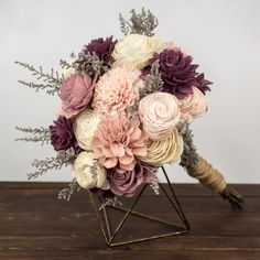 a bouquet of flowers sitting on top of a wooden table