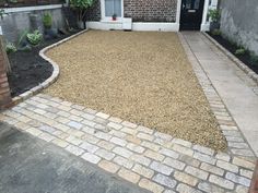 a brick walkway leading to a small house