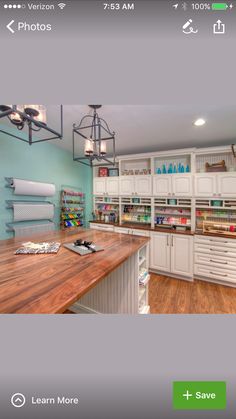 an image of a kitchen with white cabinets and wood counter tops on the phone screen