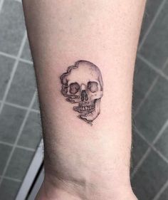 a small skull tattoo on the ankle