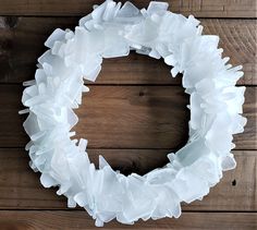 a white paper wreath sitting on top of a wooden table