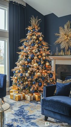 a living room decorated for christmas with a blue couch and gold ornaments on the tree