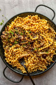 a skillet filled with pasta and mushrooms on top of a white table next to the words spicy miso pasta