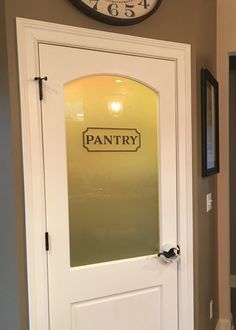 the pantry sign is on the glass door to the hallway leading into the kitchen and dining room