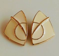 VINTAGE TRIFARI TM CREAM ENAMEL CLIP EARRING GEOMETRIC SHAPE   THIS IS A BEAUTIFUL CLASSIC TRIFARI DESIGN REPORDUCE IN THE 1990's A CREAM COLOR ENAMEL WITH GOLD TONE CLOISONNEE WITH GEOMETRIC SHAPES ABOUT 1 BY 1.25 INCH THE CLIP IS WORKING GREAT ON THE BACK YOU CAN SEE THE MARK TRIFARI TM ALL MY ITEMS ARE ESTAE SALE FOUND AND BEEN USED AND LOVED. I DO MY BEST TO DESCRIBE IF ANY FLAWS ARE NOTICE. PLEASE FEEL FREE TO ASK ANY QUESTIONS OR ADDITIONAL PICTURES PLEASE CHECK MY  STORE FOR MORE VINTAGE White Enamel Clip-on Jewelry, White Retro Clip-on Earrings As Gift, Retro White Clip-on Jewelry, White Vintage Clip-on Earrings For Formal Events, Retro White Clip-on Earrings As Gift, White Retro Formal Earrings, White Retro Earrings For Formal Occasions, Retro White Earrings For Formal Occasions, Clip Earring