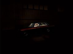 a car in the dark with two people inside