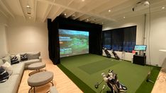 a golf simulator is set up in the living room