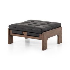 the ottoman is made out of wood and black leather