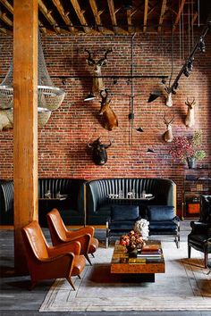 a living room filled with furniture and deer heads on the wall