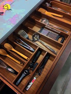 the drawer is full of kitchen utensils