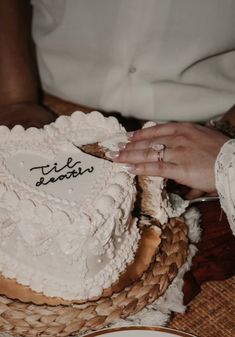 a close up of a person cutting a cake