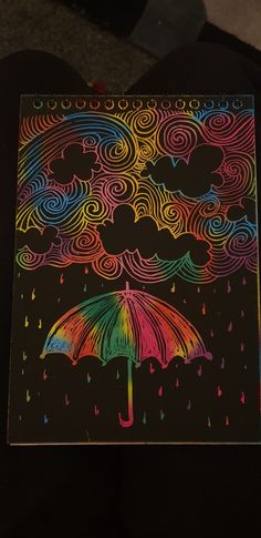 an umbrella is lit up in the dark with colorful clouds and raindrops on it