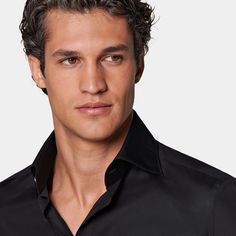 This stylish jet-black button-up is tailored to a tailored fit and is crafted in a fine poplin weave with a pronounced high widespread collar, single cuff, french placket and mother of pearl buttons. Black Fitted Sleek Shirt, Sleek Shirt With Button Closure And Spread Collar, Modern Slim Fit Solid Shirt, Slim Fit Dress Shirt For Business Casual, Modern Slim Fit Shirt, Business Casual Slim Fit Dress Shirt With Collar, Modern Solid Color Slim Fit Shirt, Semi-formal Solid Color Sleek Shirt, Sleek Fitted Shirt For Business