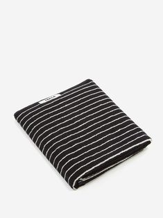 a black and white striped cloth on a white background