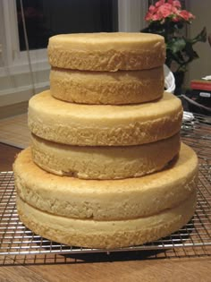 a stack of three cakes sitting on top of a cooling rack