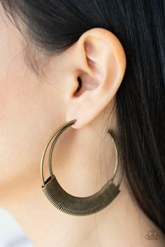 Gritty brass wire delicately wraps around the bottoms of two curving bars that coalesce into an antiqued crescent, creating a rustic hoop. Earring attaches to a standard post fitting. Hoop measures approximately 2 1/2" in diameter.

 Sold as one pair of hoop earrings. Brass Hoop Earrings, African Earrings, Brass Hoops, Earrings Inspiration, Handcrafted Accessories, Paparazzi Accessories, Colorful Earrings, Affordable Jewelry, Paparazzi Jewelry