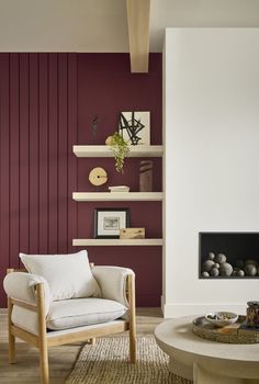 a living room with red walls and white furniture