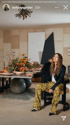 a woman sitting on a chair in front of a table