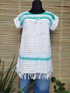 This Mexican blouse is made of pedal loom and embroidered by artisans from Oaxaca, Mx. It is ideal for the summer, very cool. This blouse comes in one size and fits S / M / L Mexican textile art has centuries of history and creativity throughout the country. Mexico is recognized as one of the leading countries with a beautiful aristic production in the textile world, miraculous hands of talented artisans from different states of the country create stunning embroidery clothing, and various items. White Tunic Blouse For Festival, White Hippie Blouse For Beach, White Hippie Blouse For The Beach, White Hippie Blouse For Vacation, Folk Style Tunic Blouse For Summer, Folk Style Short Sleeve Beach Tops, White Handmade Bohemian Top, Handmade White Cotton Blouse, White Cotton Hippie Blouse