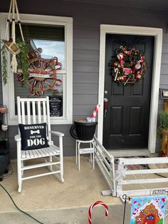 two white rocking chairs sitting on the front porch