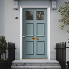 a blue front door on a grey house