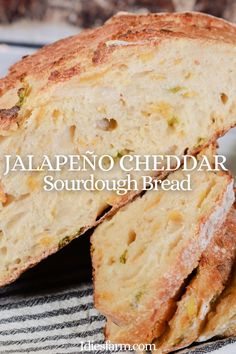 two pieces of bread sitting on top of a white and black striped plate with the words jalapeno cheddar sourdou