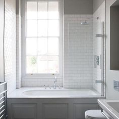 a bathroom with a tub, toilet and sink