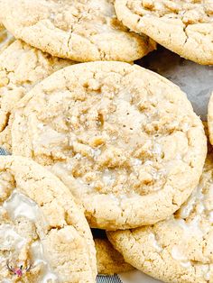 several cookies with icing and sprinkles sitting on a blue and white checkered table cloth