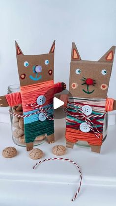 two cats made out of paper and yarn