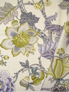 an image of a flowered fabric with green and blue flowers on it's side