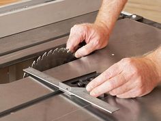 a man is using a circular saw to cut metal sheet with a circular blade on the table