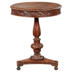 an antique wooden table with carved carvings on the top and bottom, sitting against a white background