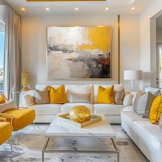 a living room filled with white couches and yellow pillows on top of each other