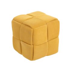 a yellow cube shaped ottoman sitting on top of a white floor