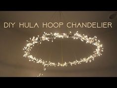 a chandelier with lights hanging from it's sides and the words diy hula hoop chandelier above it