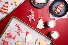 cookies decorated with icing and sprinkles sitting on top of a baking sheet