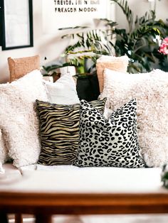 the pillows on the couch are all different shapes and sizes, but one is black and white